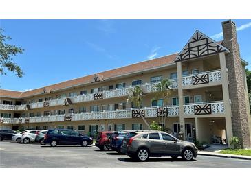 Multi-story condo building featuring decorative balconies and well-maintained landscaping on a sunny day at 2311 Brisbane St # 65, Clearwater, FL 33763