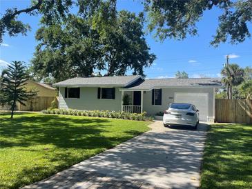 Charming single-story home with a well-manicured lawn and a private driveway leading to an attached garage at 6923 Dartmouth N Ave, St Petersburg, FL 33710