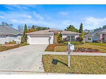 Charming single-story home with a well-manicured lawn and attached two-car garage at 4251 Whittner Dr, Land O Lakes, FL 34639