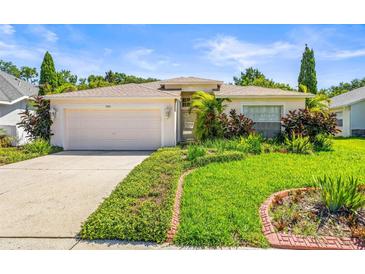 Charming single-story home with well-maintained landscaping and an attached two-car garage at 4251 Whittner Dr, Land O Lakes, FL 34639