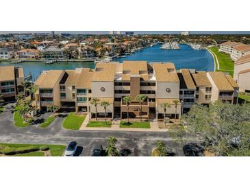 Waterfront condo complex with lush landscaping, community parking, and boat docks at 2775 Kipps Colony S Dr # 105, Gulfport, FL 33707