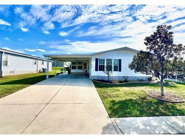 Charming single-story home features a covered carport and a well-maintained lawn at 37544 Corey Lewis Ave, Zephyrhills, FL 33541