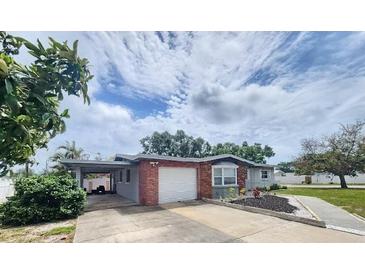 Charming single-story home featuring a brick facade, carport, and well-maintained landscaping at 12361 114Th St, Largo, FL 33778