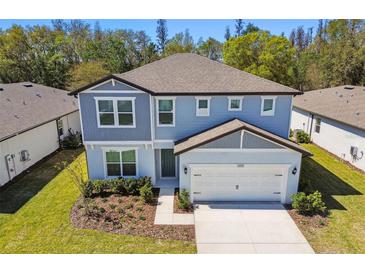 Two story home with gray siding and a two car garage at 1255 Kazaz Ct, Zephyrhills, FL 33540