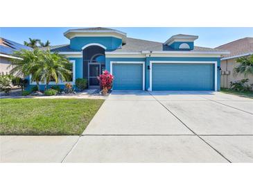 Charming, single-story home with a well-manicured lawn and a spacious two-car garage at 1778 Mira Lago Cir, Ruskin, FL 33570