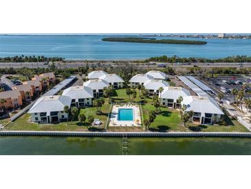 Waterfront condo community featuring a pool, covered parking, and lovely water views at 7300 Sunshine Skyway S Ln # 202, St Petersburg, FL 33711
