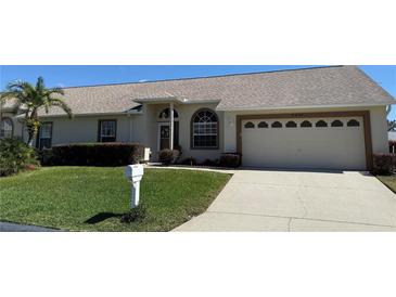 Charming single-story home with well-manicured lawn, mature landscaping, and a two-car garage at 9337 Zamora Dr, New Port Richey, FL 34655