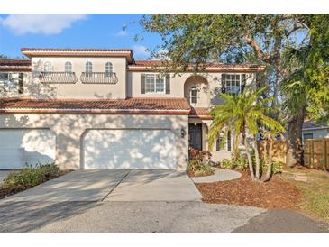 Charming two-story home with a red tile roof, two-car garage, and landscaped front yard at 6211 S Macdill Ave # 1, Tampa, FL 33611