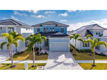 Beautiful two-story light blue home with a modern design and well-manicured landscaping at 6538 Simone Shores Cir, Apollo Beach, FL 33572