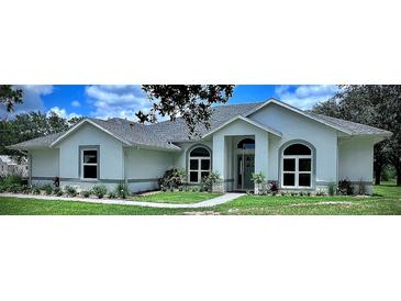 Charming single-story home with a well-manicured lawn and inviting entrance, perfect for curb appeal at 7425 245Th E St, Myakka City, FL 34251