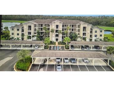 Beautiful condo exterior with covered parking, lush landscaping, and a view of the surrounding community at 17520 Gawthrop Dr # 106, Lakewood Ranch, FL 34211