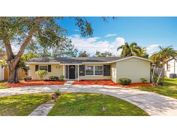 Charming one-story home featuring a well-maintained front yard with mature trees and a circular driveway at 3124 61St N Ln, St Petersburg, FL 33710