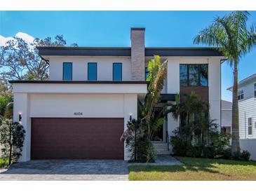 Contemporary two-story home featuring modern architecture, well-kept lawn, and a stylish brown garage door at 4604 W Lowell Ave, Tampa, FL 33629
