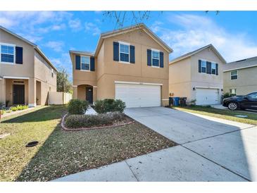 Charming two-story home with a well-maintained lawn and driveway, nestled in a sunny neighborhood at 12239 Fawn Brindle St, Riverview, FL 33578