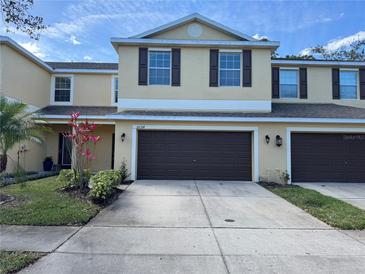 Charming two-story home with a well-maintained front yard and two-car garage in a sunny neighborhood at 20314 Starfinder Way, Tampa, FL 33647