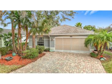 Charming single-story home featuring a brick driveway and tropical landscaping at 29523 Waggle Dr, San Antonio, FL 33576
