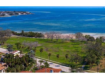 Beautiful aerial view featuring the pristine beach, lush greenery, and calm bay waters at 1200 N Shore Ne Dr # 204, St Petersburg, FL 33701