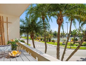 Charming balcony view with palm trees, outdoor seating and pleasant neighborhood scenery at 1200 N Shore Ne Dr # 204, St Petersburg, FL 33701