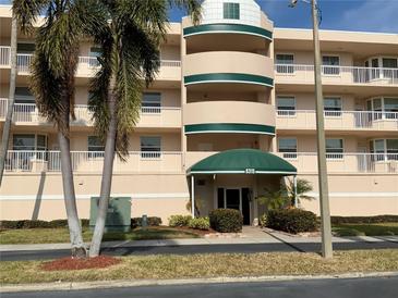 Beautiful condominium exterior with palm trees and manicured landscaping offers a welcoming entrance at 6315 Shoreline Dr # 3204, Seminole, FL 33708