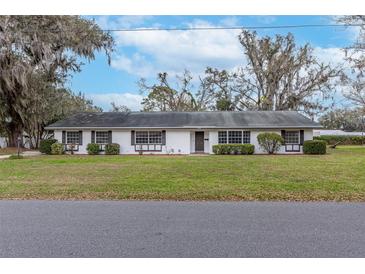 Charming single story home with a well manicured lawn and traditional architectural details at 1310 Oakdale St, Plant City, FL 33563