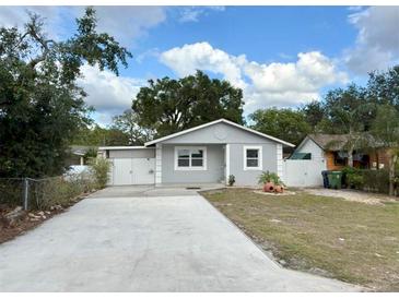 Charming single-story home featuring a well-maintained lawn and a concrete driveway at 8503 N Willow Ave, Tampa, FL 33604