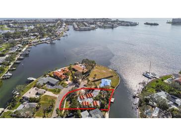Aerial view of waterfront property with lush landscaping and panoramic water views in desirable neighborhood at 4811 Paradise S Way, St Petersburg, FL 33705