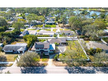 Charming neighborhood aerial view showcasing lush landscaping and proximity to a serene lake at 6342 5Th N Ave, St Petersburg, FL 33710