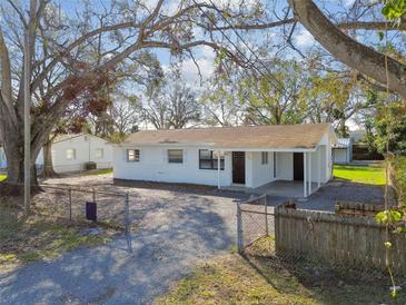 Charming single-story home with a well-maintained yard and a fenced-in gravel driveway at 7605 35Th S Ave, Tampa, FL 33619