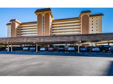 Condominium parking featuring covered spaces under the building in a well lit area at 5130 Brittany S Dr # 201, St Petersburg, FL 33715