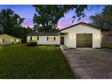 Charming home featuring a well-maintained lawn and a one-car garage, perfect for suburban living at 1520 Arnold Ave, Brooksville, FL 34601