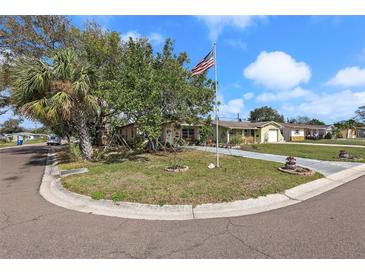 Charming single-story home with well-manicured lawn and landscaping at 5559 17Th N Ave, St Petersburg, FL 33710