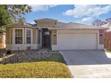 Charming single-story home featuring a well-maintained lawn, brick walkway and a two car garage at 8315 Moccasin Trail Dr, Riverview, FL 33578