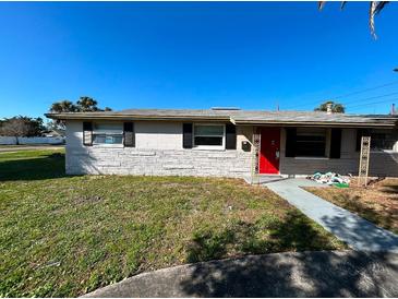 Charming single-story home with a well-maintained lawn and a striking red front door at 1601 Pennsylvania Ne Ave, St Petersburg, FL 33703