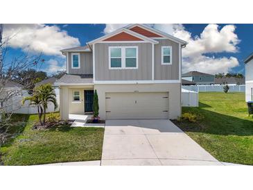 Two-story home with attached two-car garage, well-maintained lawn, and neutral color palette at 13106 Zolo Springs Cir, Riverview, FL 33579