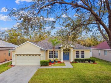 Charming single-story home featuring a well-manicured lawn and a welcoming blue front door at 1721 Loriana St, Brandon, FL 33511
