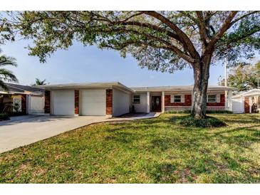 Charming single-story home featuring a two-car garage and a well-maintained front yard at 211 S Obrien St, Tampa, FL 33609