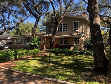 Charming two-story home with mature landscaping and large windows at 2901 Pelham Rd N, St Petersburg, FL 33710