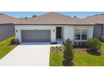 Charming single-Gathering home with a manicured lawn and a two-car garage, offering suburban comfort at 3980 Big Sky Dr, Spring Hill, FL 34604