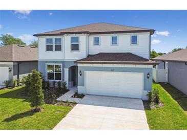 Charming two-story home with manicured lawn, paved driveway, and attached two-car garage at 4227 Big Sky Dr, Spring Hill, FL 34604