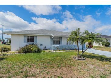 Charming single-story home with neat front lawn, accent palm tree, and a lovely blue sky at 702 W Brockton Pl # 2, Sun City Center, FL 33573