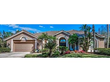 Charming home with a two-car garage, neutral paint, and landscaped yard with mature trees and colorful flowerbeds at 9101 Highland Ridge Way, Tampa, FL 33647