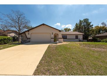 Charming single-story home boasting a two-car garage, neutral paint, and a well-manicured lawn at 11304 Sedgefield Ave, Spring Hill, FL 34608