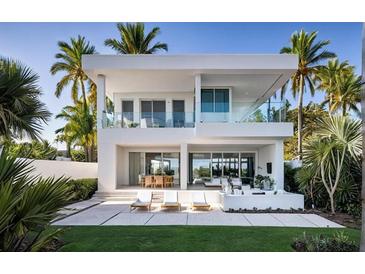 Stunning two-story modern home with balcony, patio, and lush tropical landscaping at 902 W Fribley St, Tampa, FL 33603