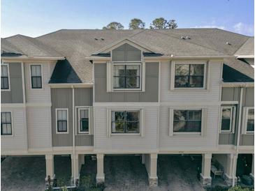Stylish townhome with neutral exterior, covered parking, and well-maintained landscaping at 9705 Bay Grove Ln, Tampa, FL 33615