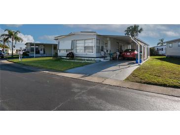 Charming single-story home features a carport, well-maintained lawn, and a welcoming facade at 13225 101St St # 462, Largo, FL 33773