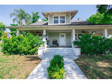 Charming two-story home boasts a welcoming front porch and lush landscaping at 602 Nw Drane St, Plant City, FL 33563