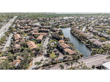Scenic aerial view of a waterfront community with lush landscaping and tranquil waterways at 6308 Newtown Cir # 8C5, Tampa, FL 33615