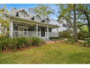 Charming two-story home with a large front porch and well-maintained landscaping at 3115 W Fair Oaks Ave, Tampa, FL 33611