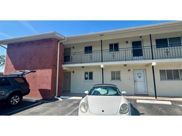 Condo building exterior featuring multiple units, carports, and parking at 4560 Overlook Ne Dr # 163, St Petersburg, FL 33703