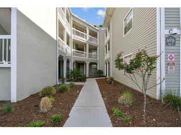 Beautiful condo complex featuring a landscaped walkway and private balconies at 6916 Stonesthrow N Cir # 9103, St Petersburg, FL 33710